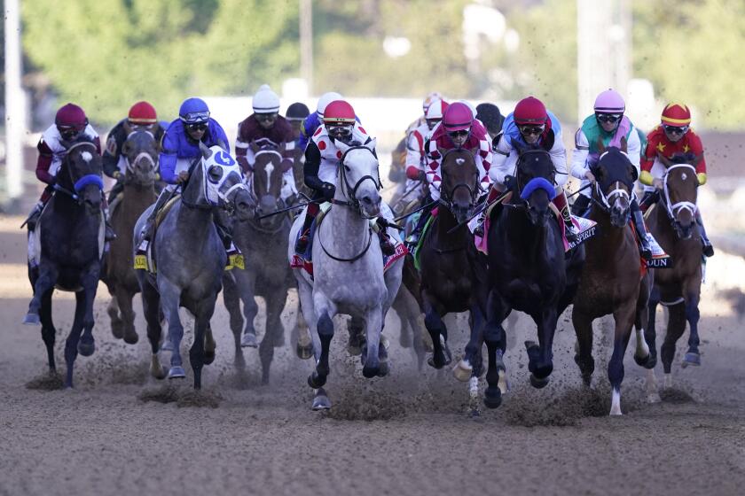 John Velazquez on Medina Spirit, third from right, leads the pack into turn one during the 147th running of the Kentucky Derby at Churchill Downs, Saturday, May 1, 2021, in Louisville, Ky. Velazquez rode Medina Spirit to victory. (AP Photo/Michael Conroy)
