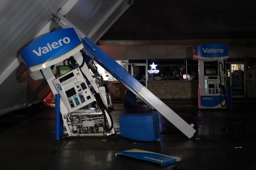The canopy of gas station, toppled by strong winds, rests at an angle, Wednesday, Jan. 4, 2023, in South San Francisco. Another winter storm moved into California on Wednesday, walloping the northern part of the state with more rain and snow. It's the second major storm of the week in the parched state. It follows storms that brought threats of flash flooding and severe thunderstorms across the southern U.S. and heavy snow in the upper Midwest. (AP Photo/Godofredo A. Vásquez)