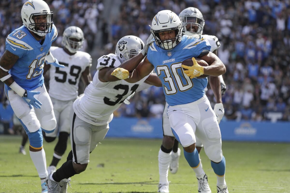 Chargers running back Austin Ekeler outruns the Oakland Raiders defense for a 44-yard touchdown on a screen pass from Philip Rivers at StubHub Center on Sunday.