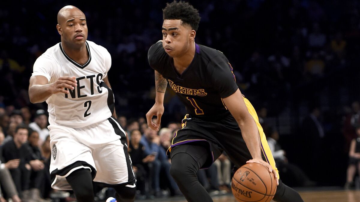 Lakers point guard D'Angelo Russell drives past Nets guard Jarrett Jack in the first half of a game Nov. 6 in Brooklyn.