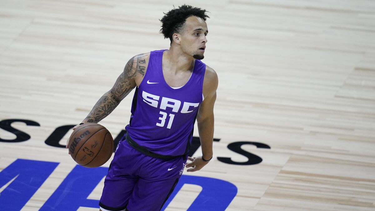 Kings guard Marcus Graves brings the ball up court.