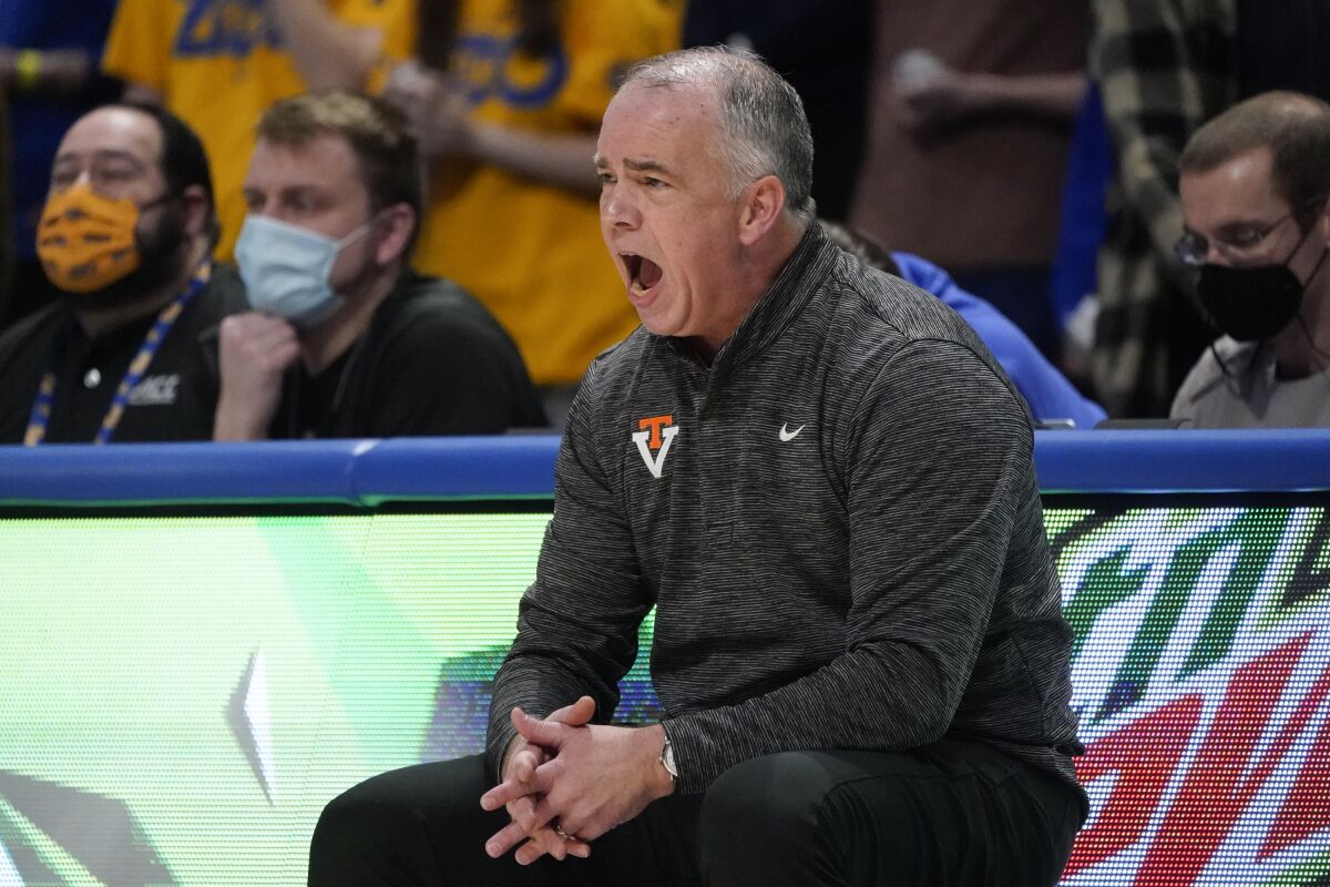 Virginia Tech head coach Mike Young yells to his team as they play against Pittsburgh during the first half of an NCAA college basketball game, Saturday, Feb. 5, 2022, in Pittsburgh. (AP Photo/Keith Srakocic)