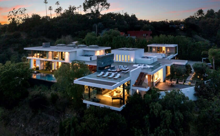 The 11,000-square-foot showplace sits on a three-acre promontory and features a rooftop deck overlooking the canyons.