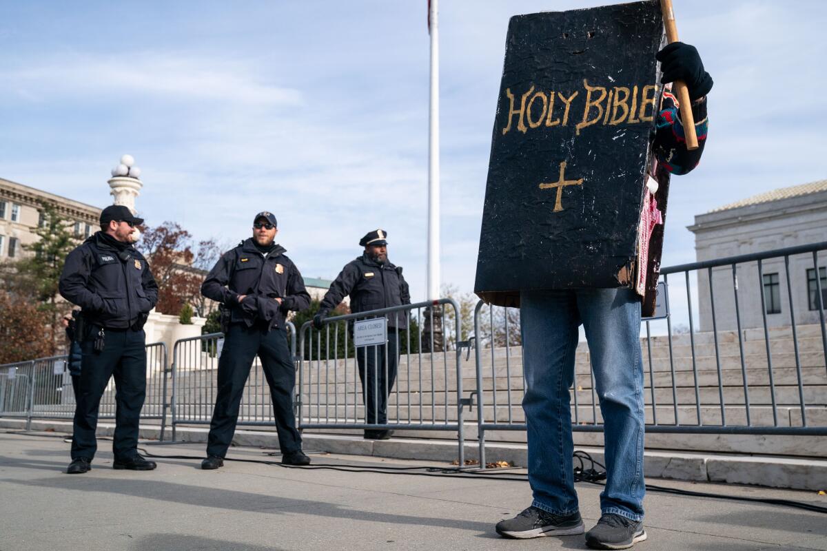 A person wears a Bible costume. 