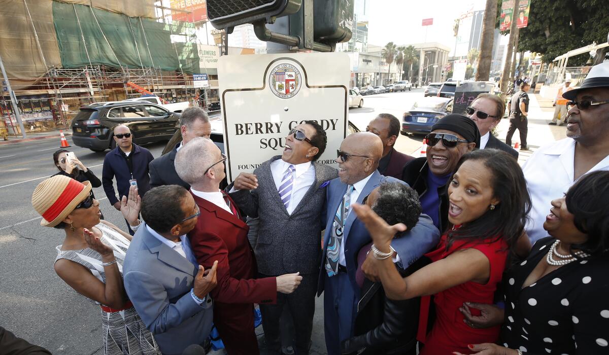 Berry Gordy, center right, celebrates with Smokey Robinson, center, Stevie Wonder, right, family and Los Angeles City Councilmen Mitch O'Farrell and Herb Wesson, as they dedicate Berry Gordy Square.