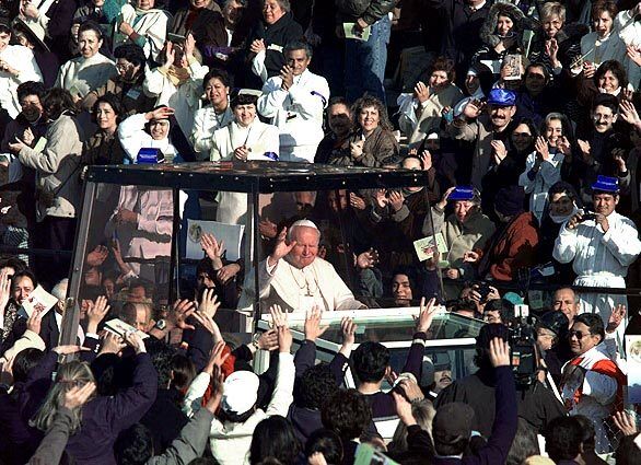 Pope John Paul II is back in his protective popemobile as he makes his way to the Basilica of Guadalupe in Mexico City in January 1999.