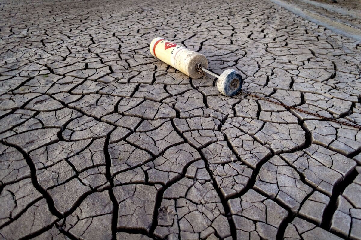 A buoy lies on dried mud at Lake Mead in July 2022.