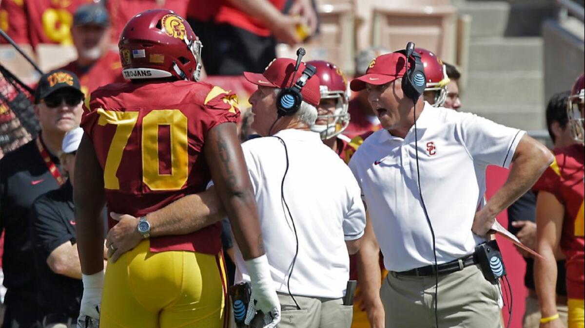USC Coach Clay Helton yells at left tackle Chuma Edoga after his ejection from the Trojans' 45-7 victory over Utah State for making contact with an official on Sept. 10.