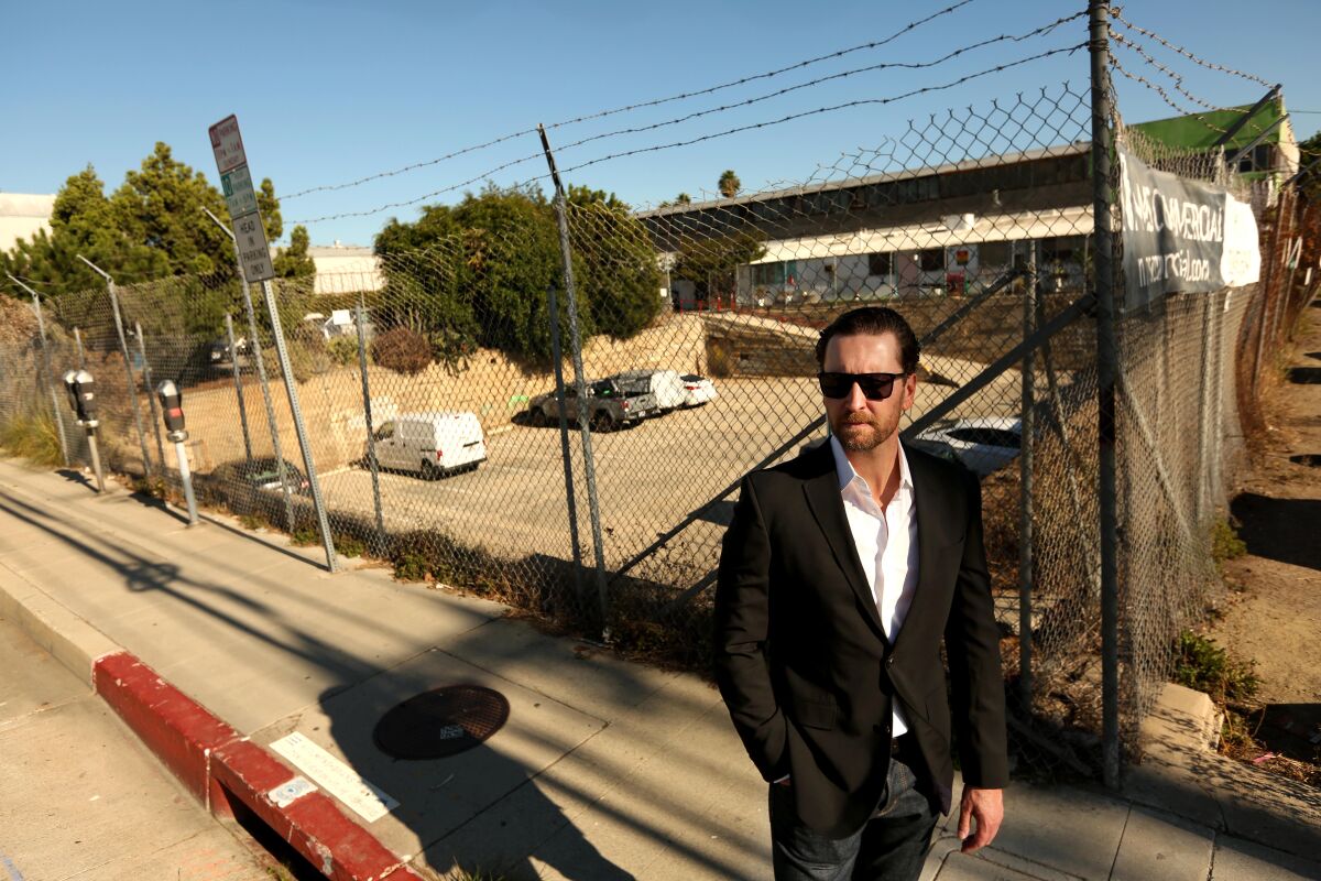 Developer Scott Walter stands next to a proposed building site.