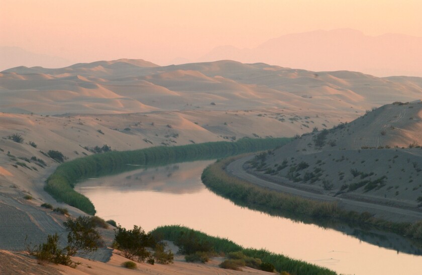 The All-American Canal winds through the Algodones Dunes in Imperial County, bringing water from the Colorado River to Imperial Valley farms and cities.