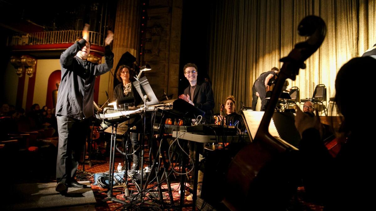 Nicholas Britell, center, celebrates with members of the Wordless Music Orchestra after performing the "Moonlight" score live during a screening of the film in the Million Dollar Theatre.