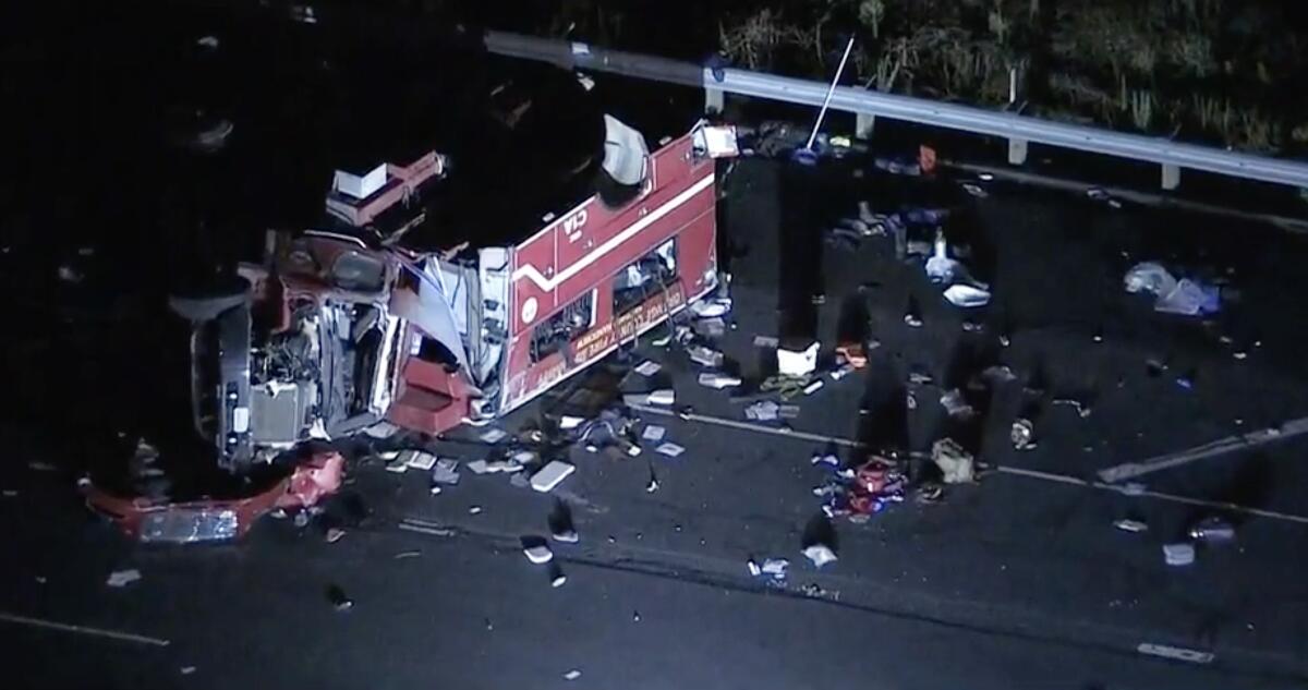 A rolled-over fire truck and debris on a freeway