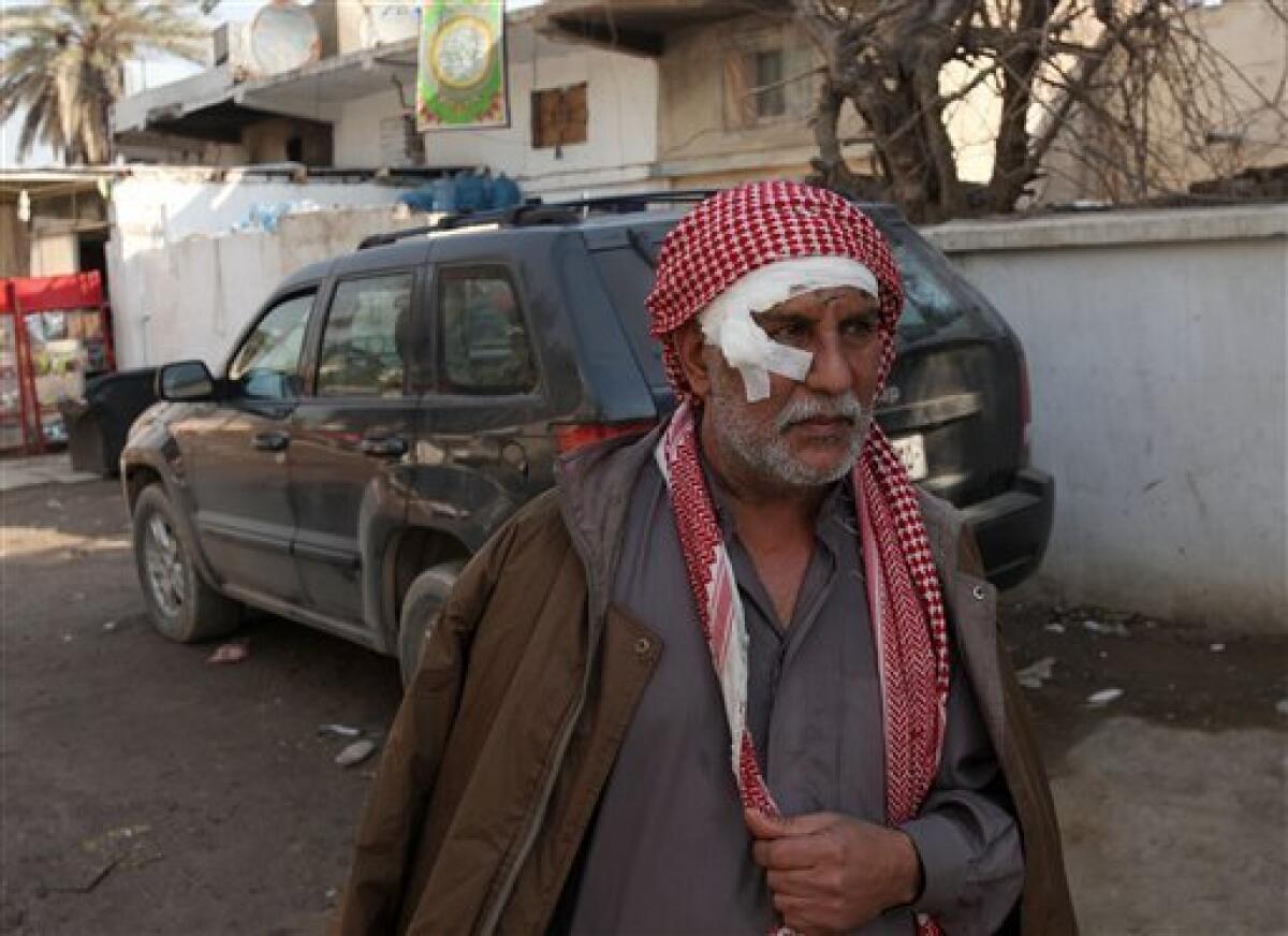 Ali Hussein is seen after being injured in a car bomb attack in Baghdad, Iraq, Tuesday, Dec. 15, 2009. A series of car bombs ripped through downtown Baghdad near the heavily fortified Green Zone. (AP Photo/Karim Kadim)