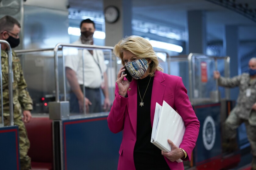 Members of the National Guard stand by the Senate subway as Sen. Lisa Murkowski (R-Alaska) arrives.