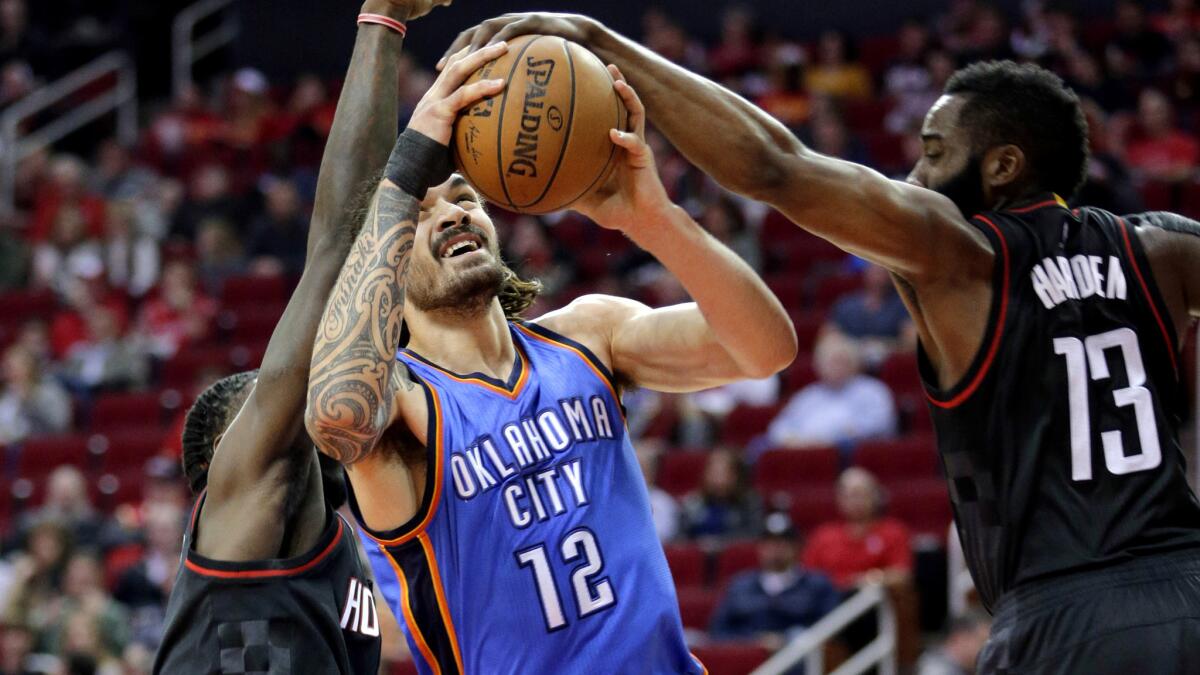 Thunder center Steven Adams (12) has his shot blocked by Rockets guard James Harden (13) during the first half Thursday night.