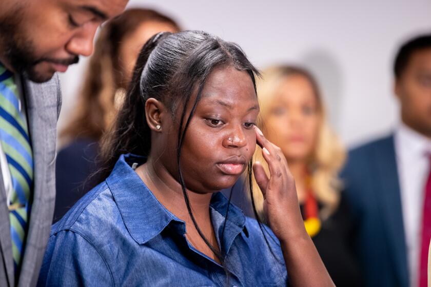 Ladera Heights, CA - July 25: Yeayo Russell, victim at the center of controversial video of L.A. sheriff's deputies punching her as she held her baby during a traffic stop, listens as her attorneys discuss the filing of charges during a press conference at offices of Douglas Hicks Law on Tuesday, July 25, 2023 in Ladera Heights, CA. (Brian van der Brug / Los Angeles Times)