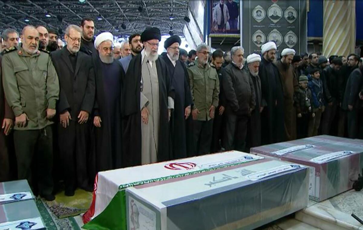 Iranian Supreme Leader Ayatollah Ali Khamenei leads a prayer over the coffins of Gen. Qassem Soleimani and his comrades, who were killed in Iraq in a U.S. drone strike.