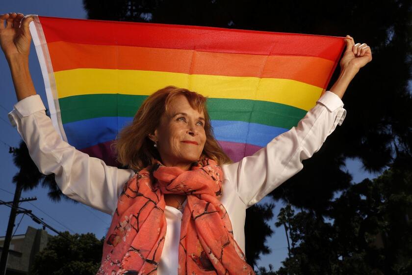 TORRANCE, CA-JUNE 1, 2018: Lynn Segerblom, one of the women behind the creation of the first rainbow flags for the 1978 pride parade in San Francisco, is photographed with a rainbow flag near her home in Torrance on June 1, 2018. (Mel Melcon/Los Angeles Times)