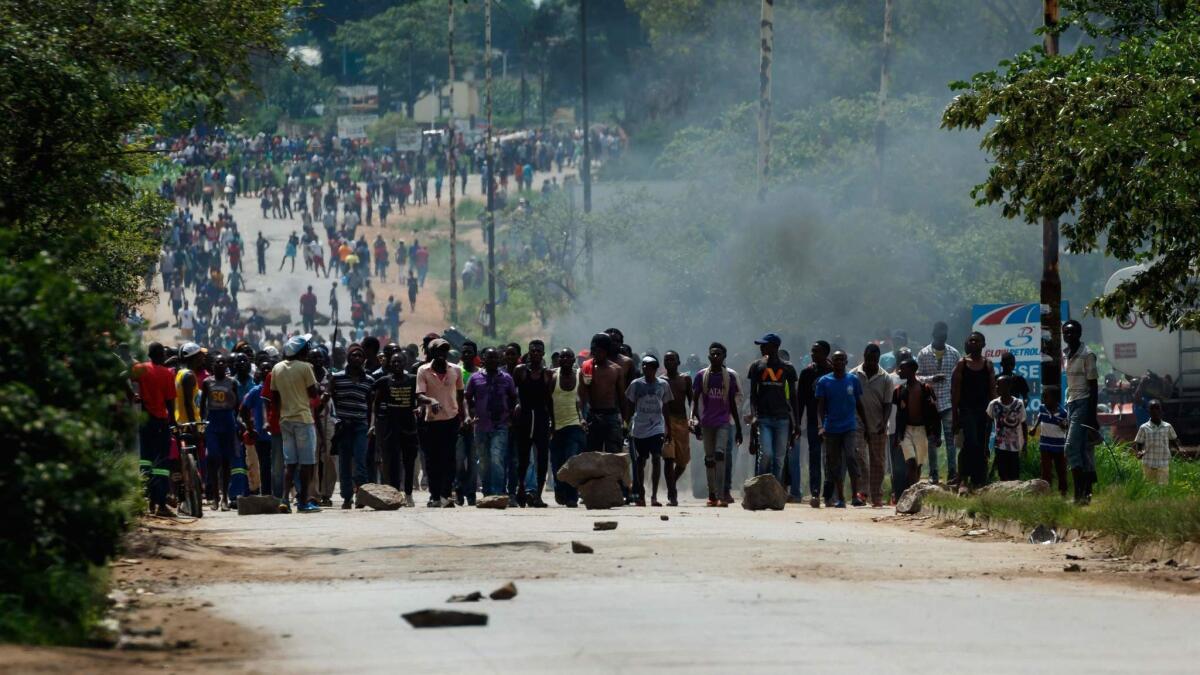 Angry protesters barricade the main route to Harare, the capital of Zimbabwe, after the government more than doubled gas prices.