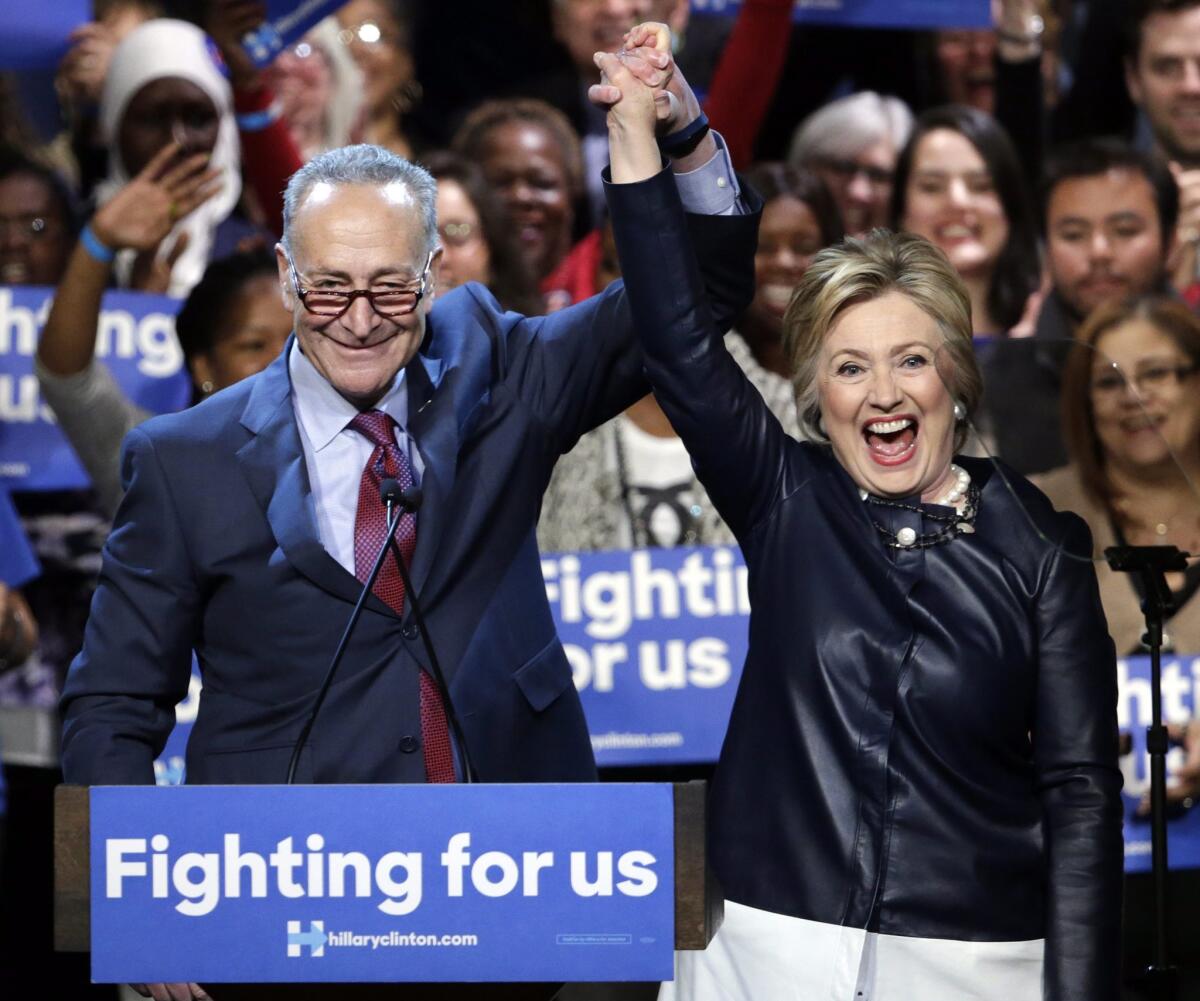 Sen. Chuck Schumer (D-N.Y.) introduces Democratic presidential candidate Hillary Clinton during a campaign event at the Apollo Theater in Harlem.