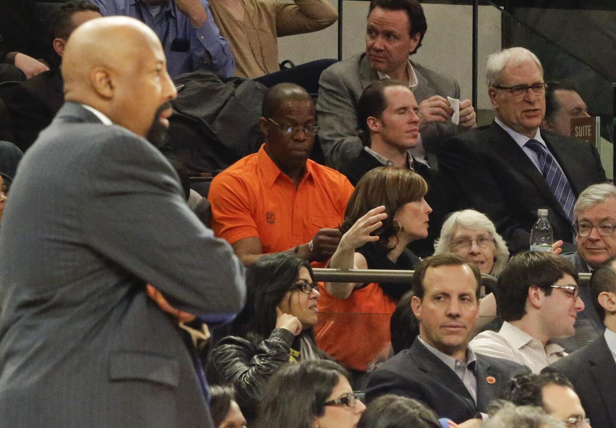 New York Knicks President Phil Jackson, far right, and then-coach Mike Woodson, far left, watch their team play the Wizards.