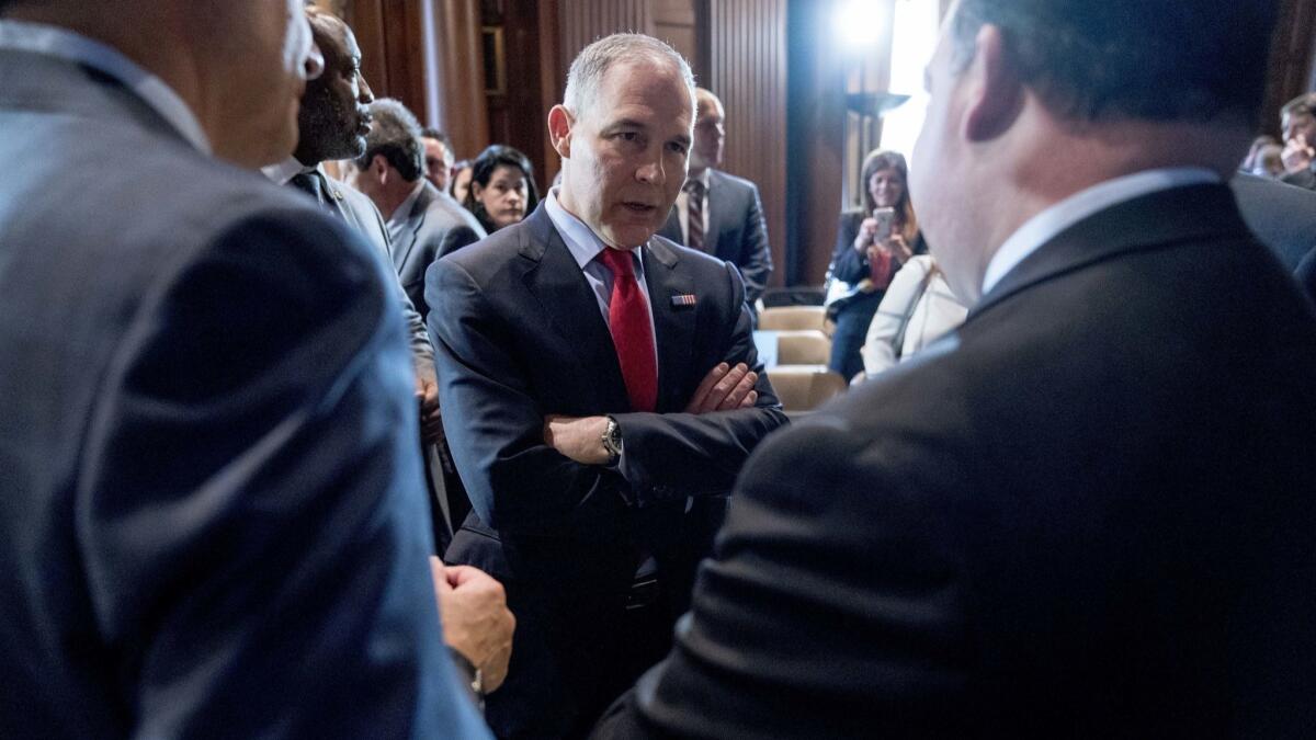 U.S. Environmental Protection Agency Administrator Scott Pruitt speaks with auto industry leaders following an event Tuesday announcing his decision to roll back Obama administration fuel standards.