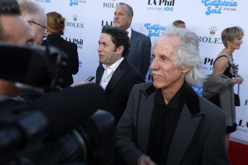LOS ANGELES, CALIF. - SEP. 28, 2018. Gustavo Dudamel, left, and Doors drummer John Densmore talk with reporters on the red carpet before the opening of the symphony's centennial season with a "California Soul" gala at the Walt Disney Concert Hall in downtown Los Angeles on Thursday, Sept. 28, 2018. (Luis Sinco/Los Angeles Times)