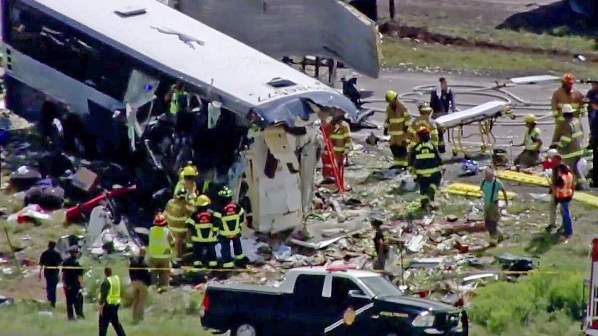 An image from video shows first responders working the scene after a semi-truck crashed into a Greyhound bus on Interstate 40 near Thoreau, N.M.