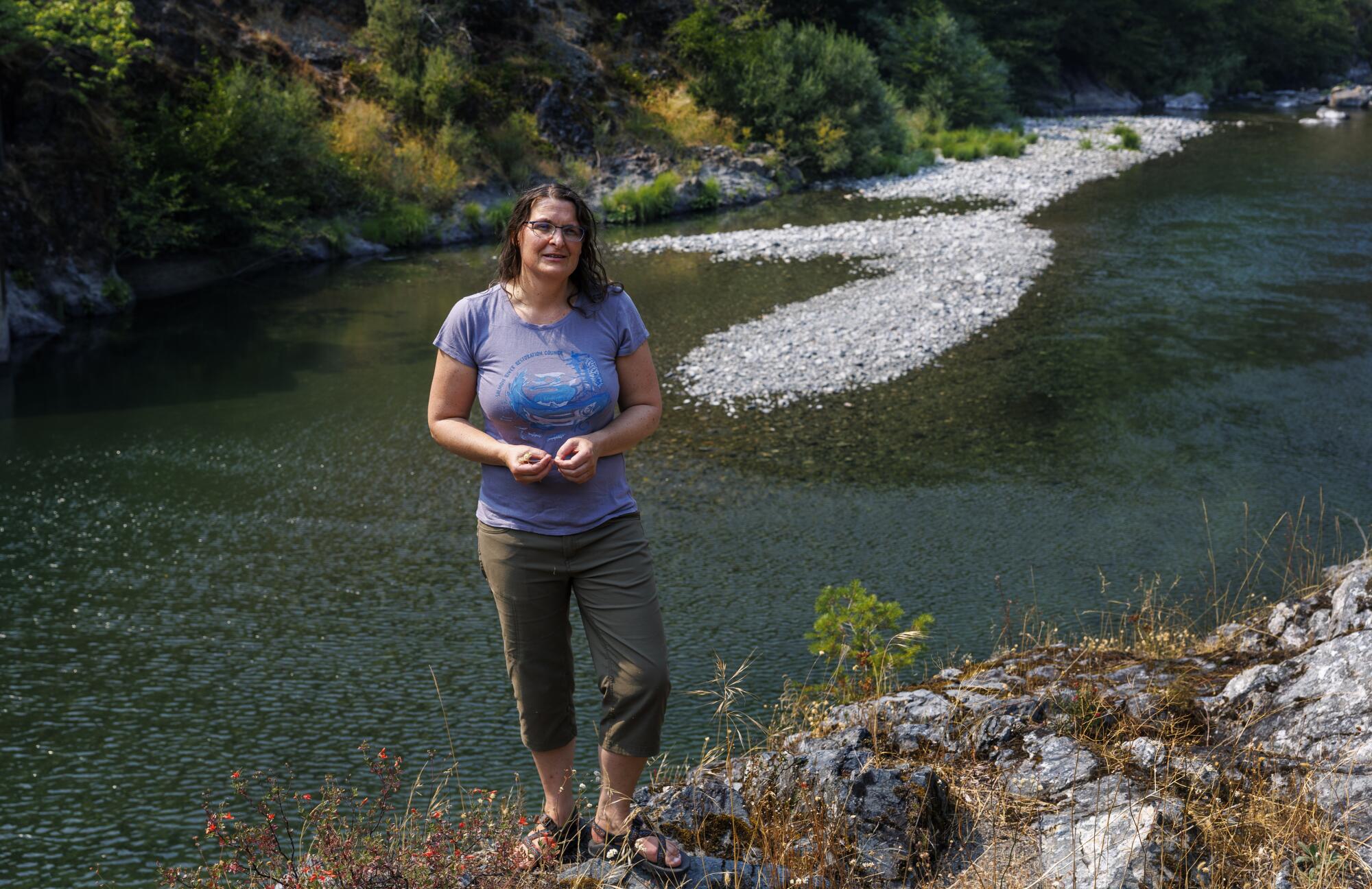 Karuna Greenberg stands by the Salmon River, where salmon have been returning to spawn.