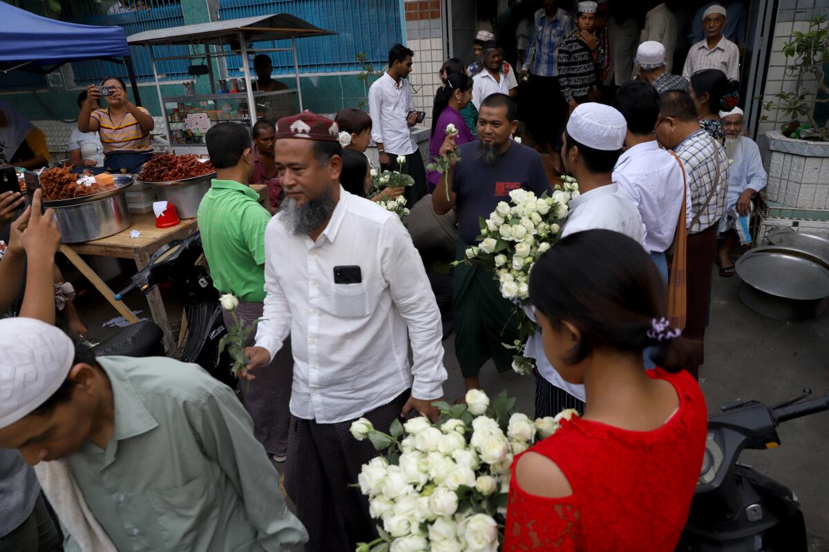 Buddhists at Joon Mosque in Mandalay give white roses to Muslim community members in May.