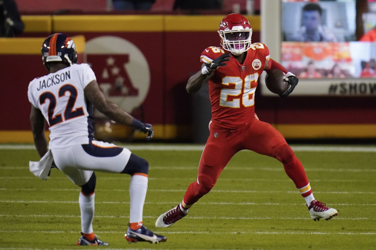 Kansas City Chiefs running back Le'Veon Bell makes a move on Denver Broncos strong safety Kareem Jackson.