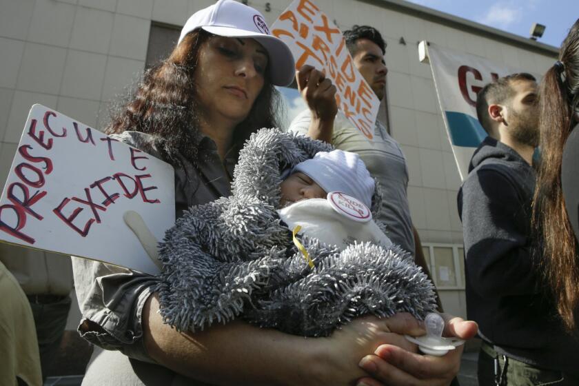Boyle Heights resident Veta Gashgai, holding her son, at a news conference last year with other opponents of the Exide battery-recycling plant in Vernon.