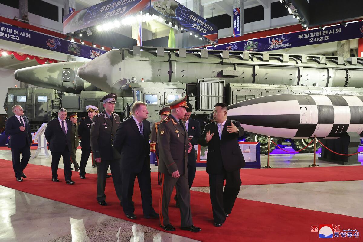 North Korean leader Kim Jong Un and a Russian delegation led by its defense minister visit an arms exhibit in Pyongyang.