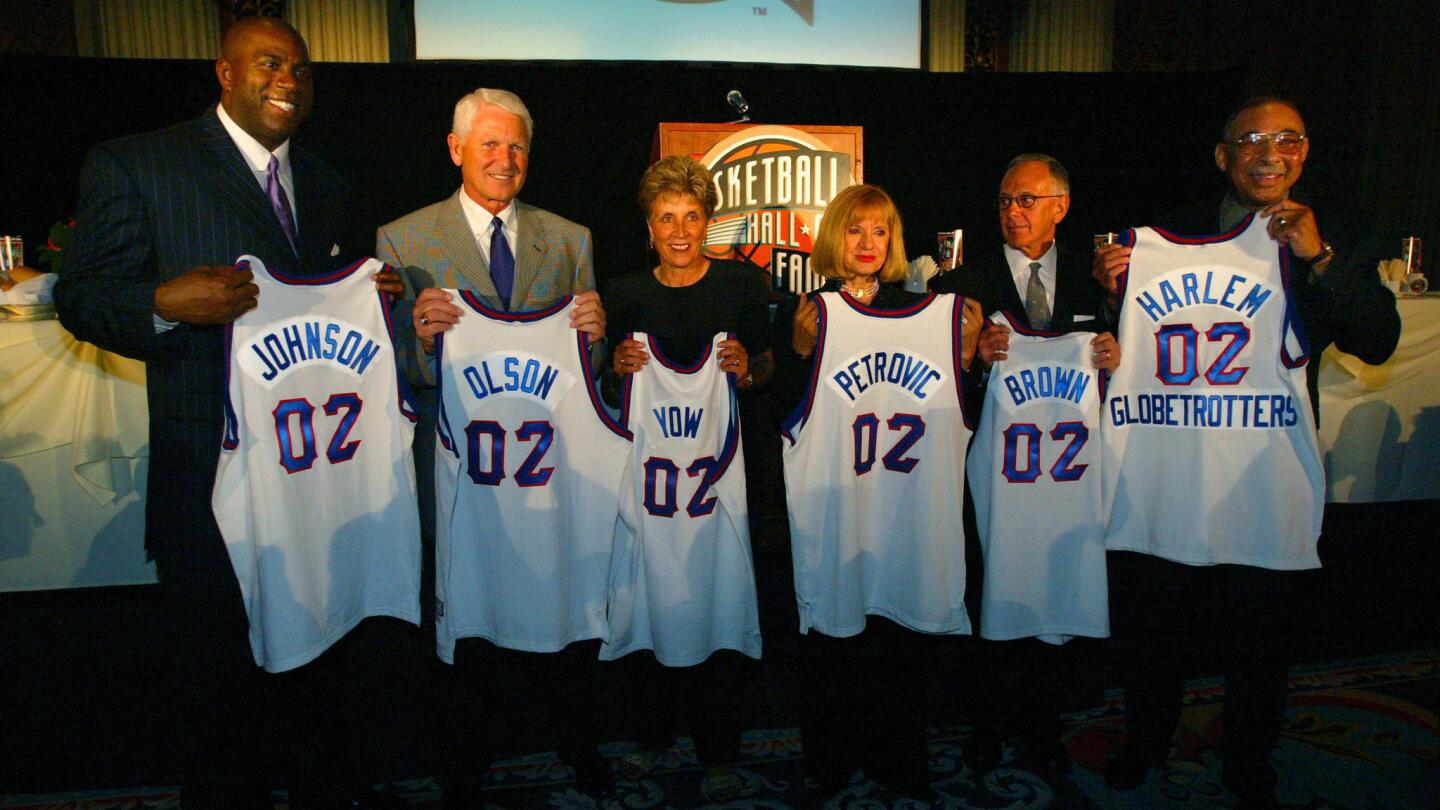 Basketball Hall of Fame inductees for 2002: (from left) Magic Johnson, Lute Olson, Kay Yow, Drazen Petrovic's mother, Larry Brown and The Harlem Globetrotters.