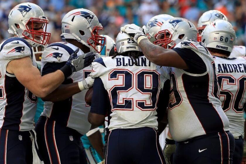 Patriots running back Legarrette Blount celebrates after scoring a touchdown against the Dolphins during a game on Jan. 1.