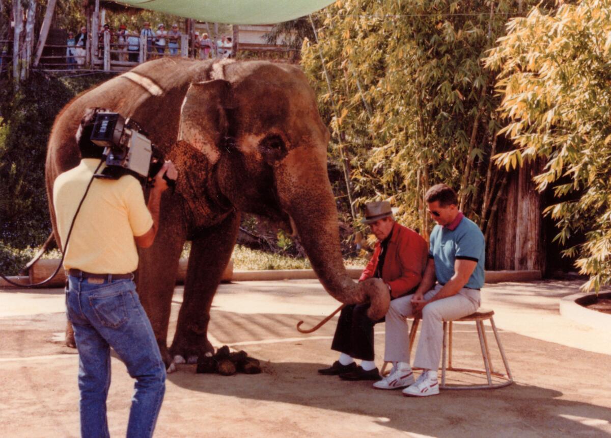 Luis Fuerte, left, shoots a 1989 Videolog with Huell Howser about a retired animal trainer reuniting with elephant Nita.