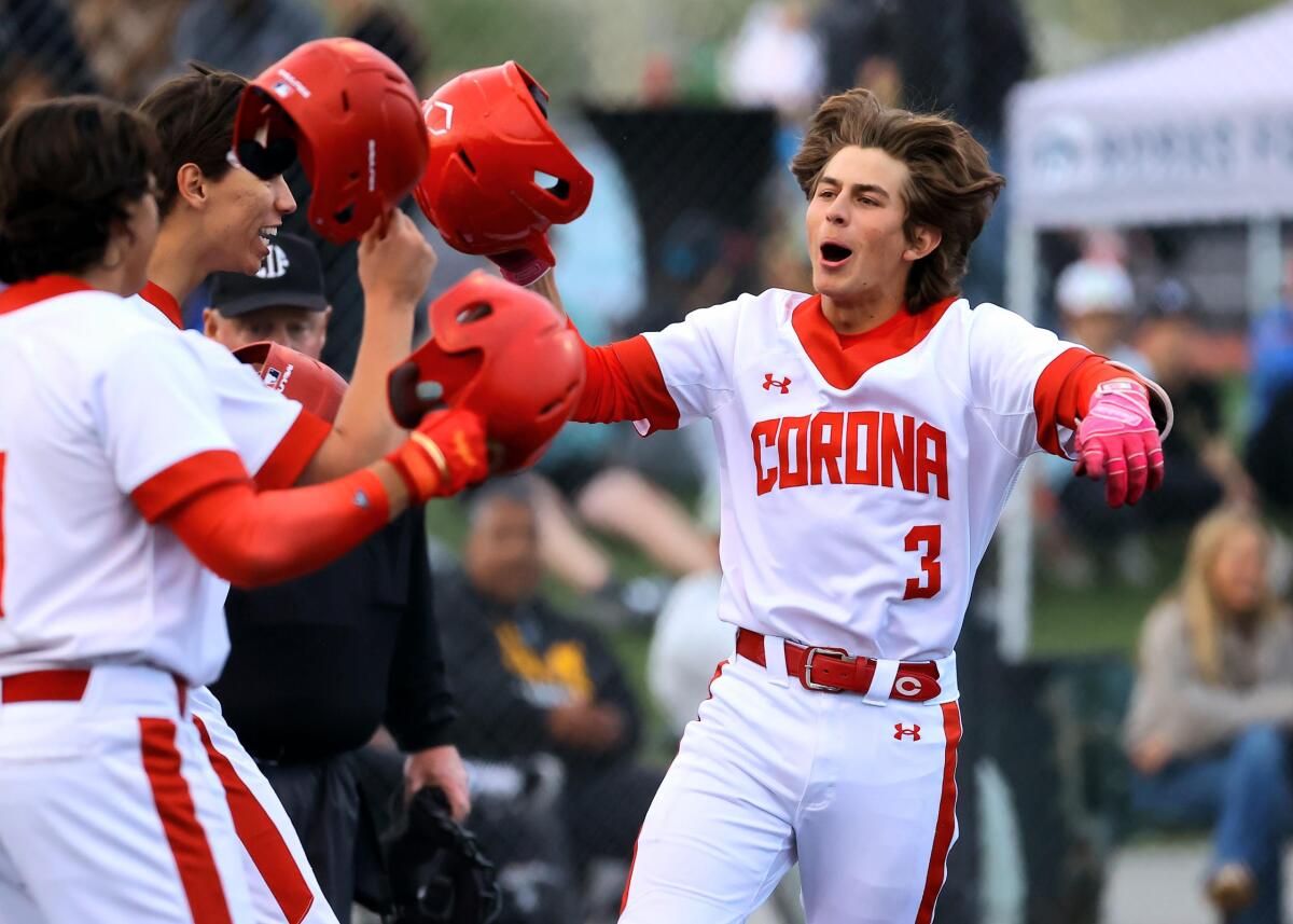 Billy Carlson of Corona celebrates after hitting a three-run home run in the first inning against La Mirada.
