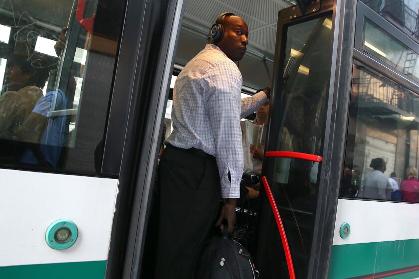 A commuter stands inside an Alameda-Contra Costa (AC) Transit bus in Oakland. Transit workers are threatening to strike starting at 12:01 a.m. Wednesday.