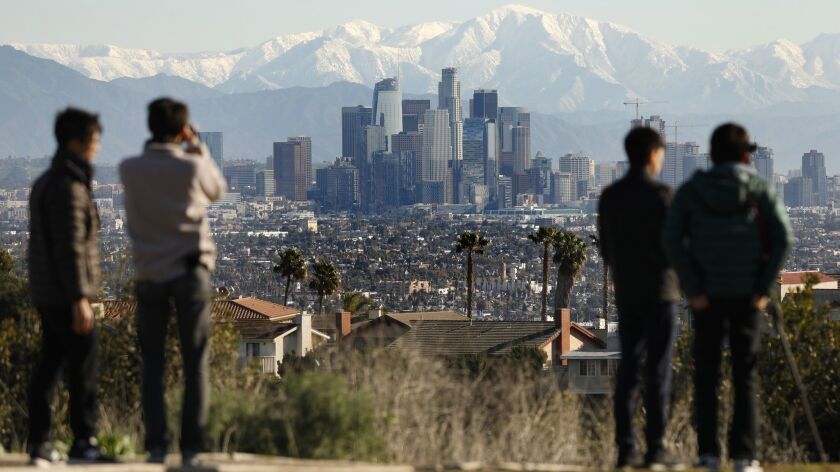 The San Gabriel Mountains dusted with snow were a rare but beautiful backdrop above downtown Los Angeles on Feb. 6.