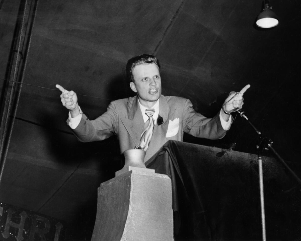 Oct. 30, 1949: Rev. Billy Graham delivers a sermon to a crowd attending a tent revival at Washington Boulevard and Hill Street. 