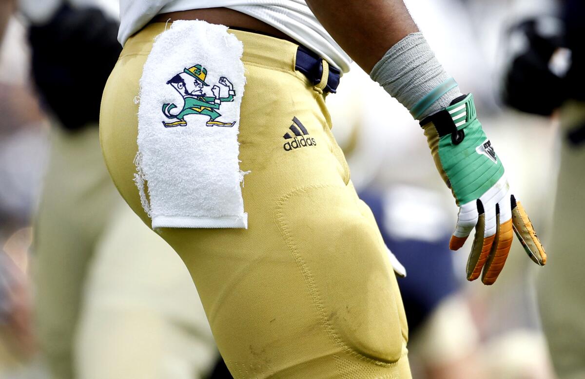 Notre Dame's fighing Irish logo on a towel hanging from a football player's waist
