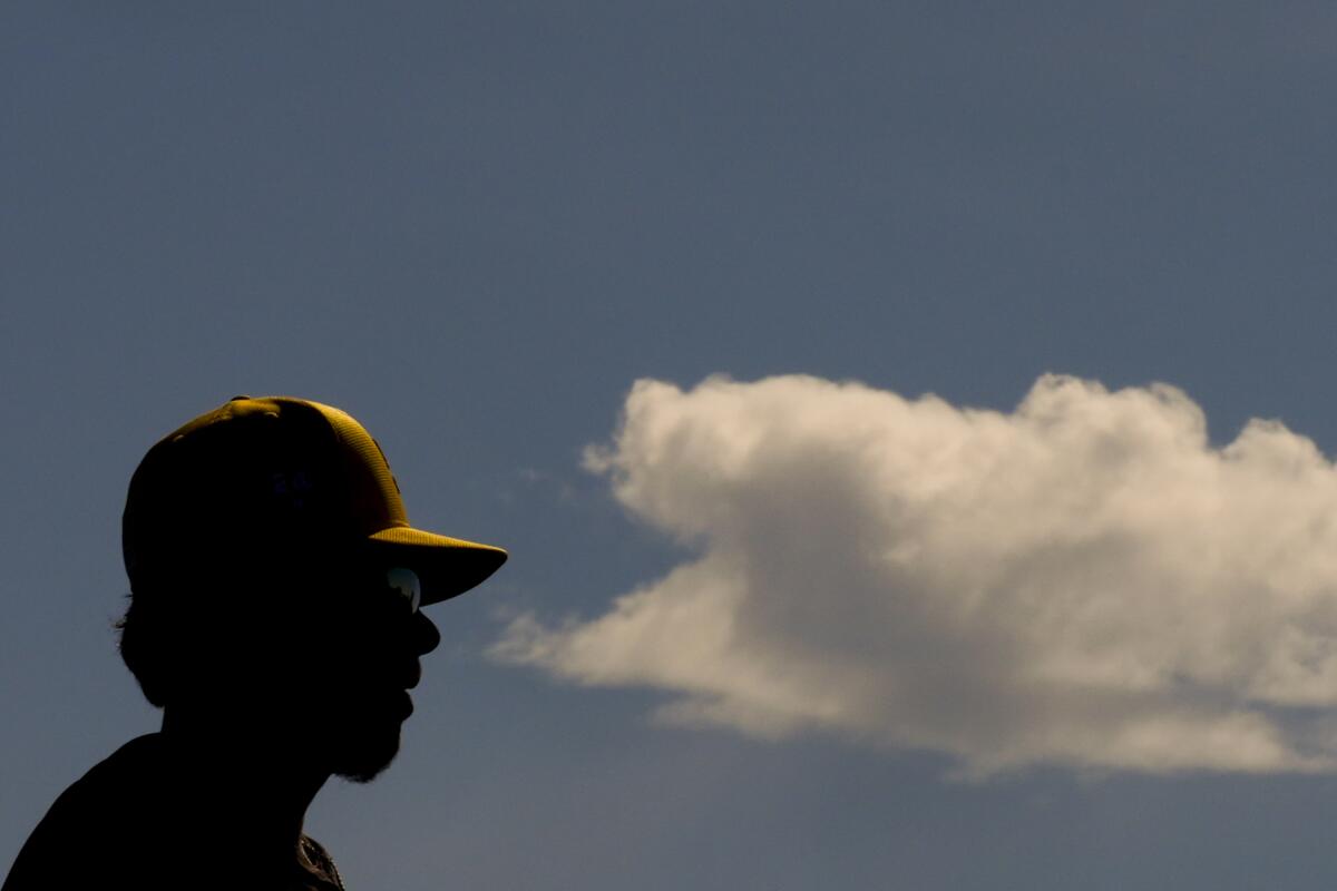Padres infielder Graham Pauley stands near a passing cloud during spring training workouts.