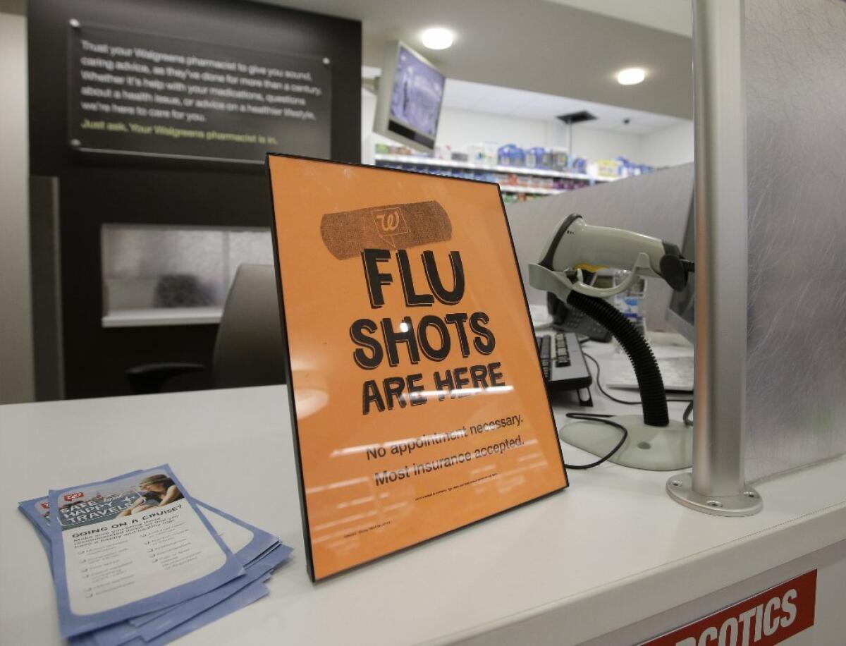 A pharmacy sign advertises availability of flu shots.
