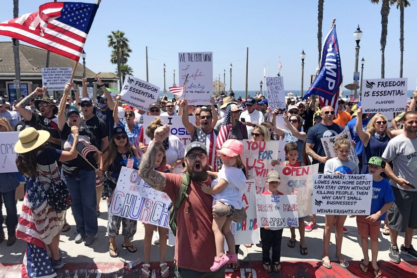 Huntington Beach CA. MAY 1, 2020 - Protesters converged on Huntington Beach Friday, May 1, 2020, to demand stay-at-home rules in California be lifted and to express their displeasure with Gov. Gavin Newsom's directive closing local beaches to slow the spread of coronavirus. (Allen J. Schaben / Los Angeles Times)