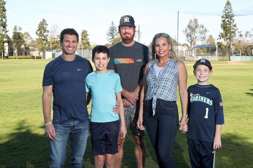 League President Jared Eisenberg, center, with the Tarman family members Dan, older son Leo (13), wife Alicia and younger son Miles (9), are registered with the Newport Harbor Baseball Association. The association has added a new Champions Division for special needs children. Leo is with the new Champions Division and Miles is a pitcher for with Mariners Select 10U team.