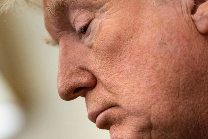 A close-up of Donald Trump frowning