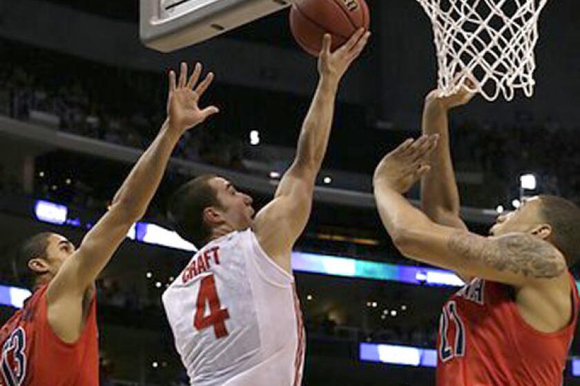 Ohio State guard Aaron Crafts splits two Arizona defenders for a basket in the first half Thursday night.