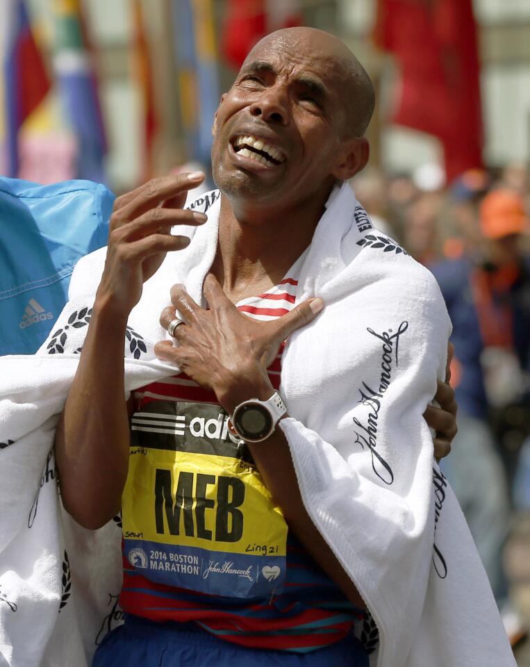 Meb Keflezighi, a Boston Marathon winner, throws out the ceremonial first  pitch before a baseball game between the Boston Red Sox and the Los Angeles  Angels, Friday, April 14, 2023, in Boston. (