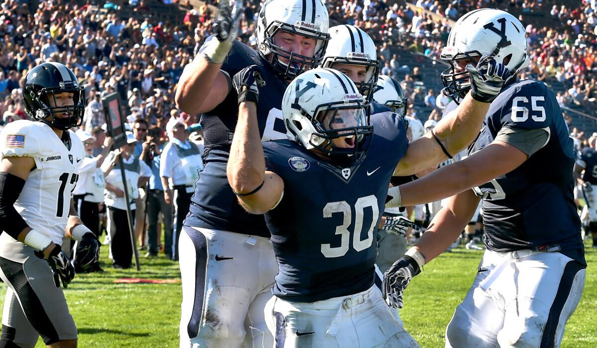 Yale running Tyler Varga, center, celebrates a third-quarter touchdown against Army on Saturday in New Haven, Conn.