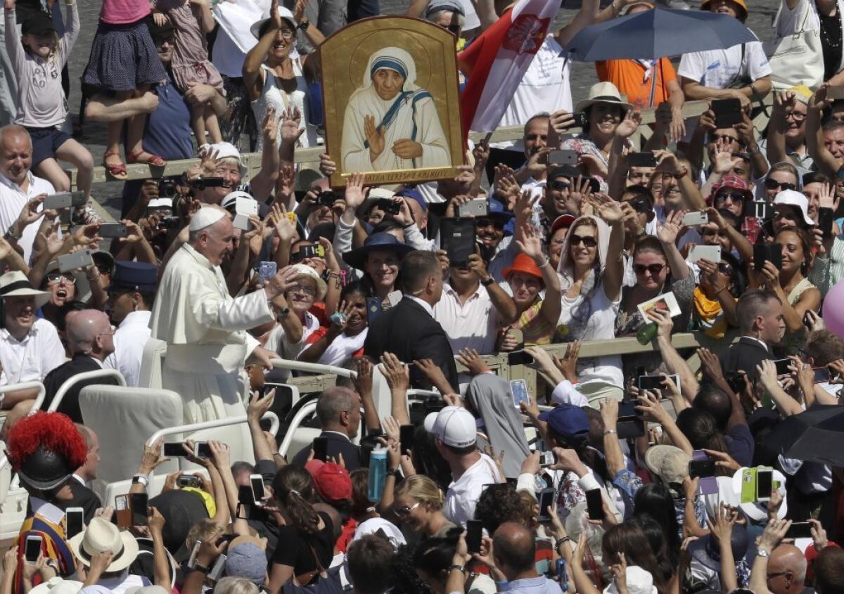 Pope Francis passes in front of a portrait of Mother Teresa at the end of a canonization ceremony in St. Peter's Square at the Vatican on Sunday. Francis declared Mother Teresa a saint.